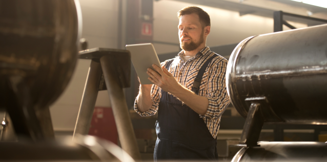 Man works on tablet in work room.