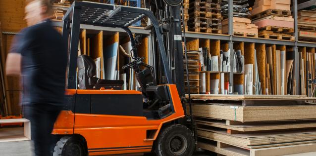 orange forklift lifting wood